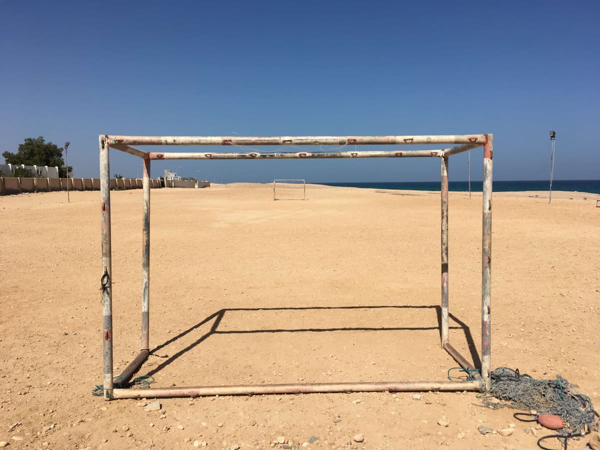 soccer goals without a net on a dirt travel pitch